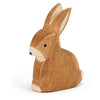 An Ostheimer Rabbit - Sitting wooden figurine, predominantly in a natural wood color with white accents on its face and ears, sitting upright against a plain white background.