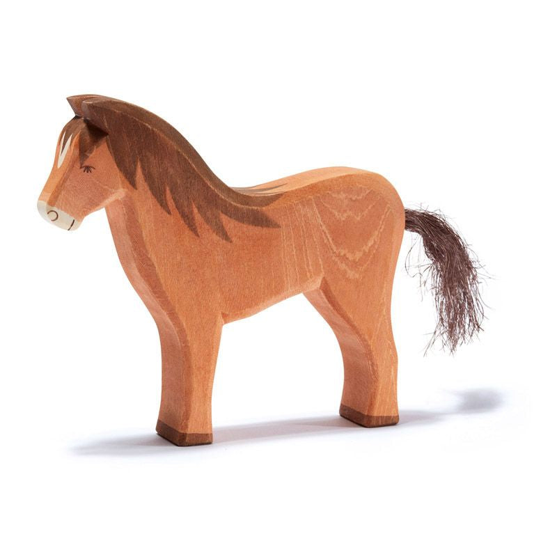 A Ostheimer Brown Horse with a carved mane and tail, showcasing smooth edges and natural wood grain patterns, representative of handcrafted wooden toys, set against a plain white background.