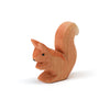 A handcrafted Ostheimer Squirrel - Sitting, carved with detailed features and an upright bushy tail, standing isolated on a white background.