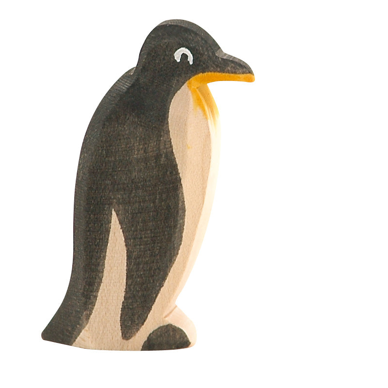 A handcrafted Ostheimer Penguin - Head Straight painted predominantly in black and white with details such as eyes and a yellow beak, standing upright against a white background.