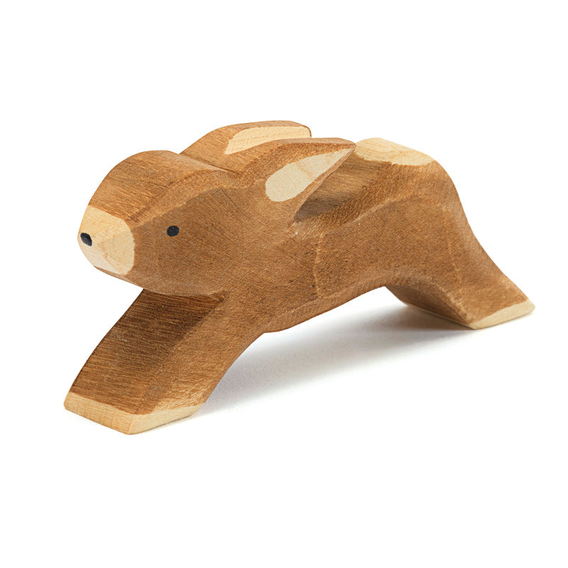 A handcrafted wooden toy Ostheimer Rabbit - Running with a natural finish, featuring simplified shapes and visible wood grain, positioned on a white background.