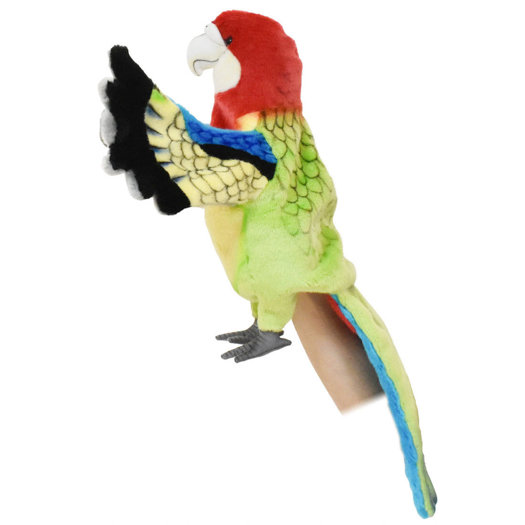 The Parrot Puppet from HANSA animals features vibrant red, green, blue, and yellow feathers and is designed to perch on your hand with its wings spread wide. Expertly crafted with exquisite attention to detail, this realistic stuffed animal brings lifelike imaginative play to life.
