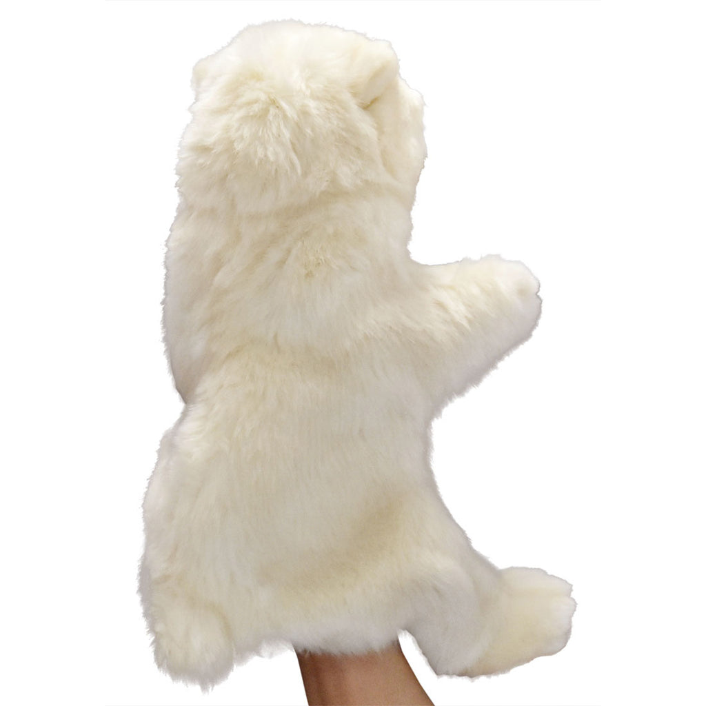 A hand holds the Polar Bear Puppet, shown from the back against a white background. The puppet has soft, fluffy fur and stands upright with arms extended, evoking the look of high-quality animal toys.