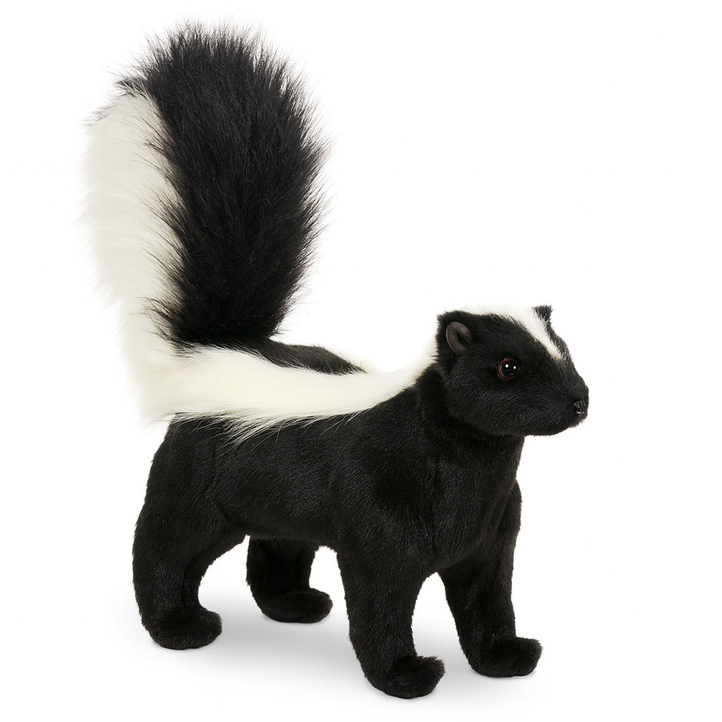 The Skunk Stuffed Animal stands upright with black fur, a bushy tail striped and tipped in white, plus a white stripe from head to back—one of HANSA's realistic plush creations.