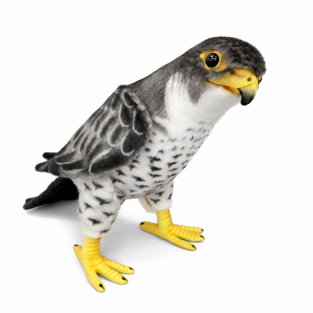 The Falcon Bird Stuffed Animal features gray and white patterned fabric, a yellow beak, and yellow feet. This hand-sewn plush toy is inspired by realistic birds and is shown against a plain white background.