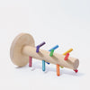 Grimm's Sorting Helper for Building Rings - Rainbow is a wooden toy with a round base, cylindrical handle, and small colorful rainbow dowels sticking out in various directions.