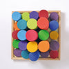 Grimm’s Large Building Rollers Rainbow featuring twenty-five multicolored wooden cylinders in a square wooden tray, designed for color sorting and motor skills development.