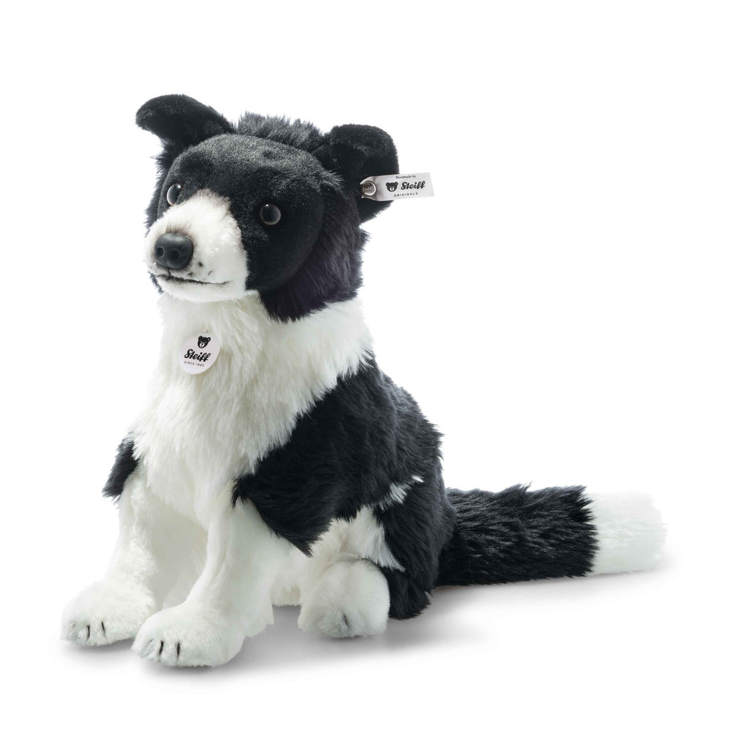 The Steiff Jaycee Border Collie Dog is a collectible plush with black and white fur, upright posture, and signature Steiff tags on its ear and chest—perfect for any collection. Shown against a plain white background.