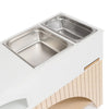 An elevated pet feeder with two stainless steel bowls positioned side by side in a white wooden stand. The stand, reminiscent of the craftsmanship seen in the Milton & Goose Mud Kitchen (Made in USA) collection, features a wooden arch beneath the bowls and a logo on the side reading "MILONGECORE.