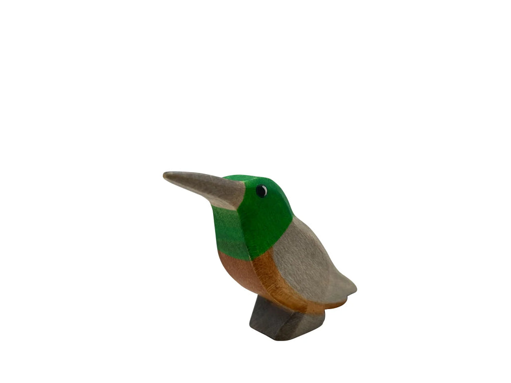 A Handmade Holzwald Kolibri Bird, painted with green, white, and brown colors, isolated on a white background. This sustainable toy adds an eco-friendly touch to any collection.