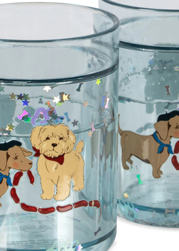 The Konges Sloejd Glitter Cups - Today's Special (2 Pack) features two playful kids’ drinkware glasses with cartoon dogs, colorful star confetti, and vibrant details—perfect for adding fun to every sip.