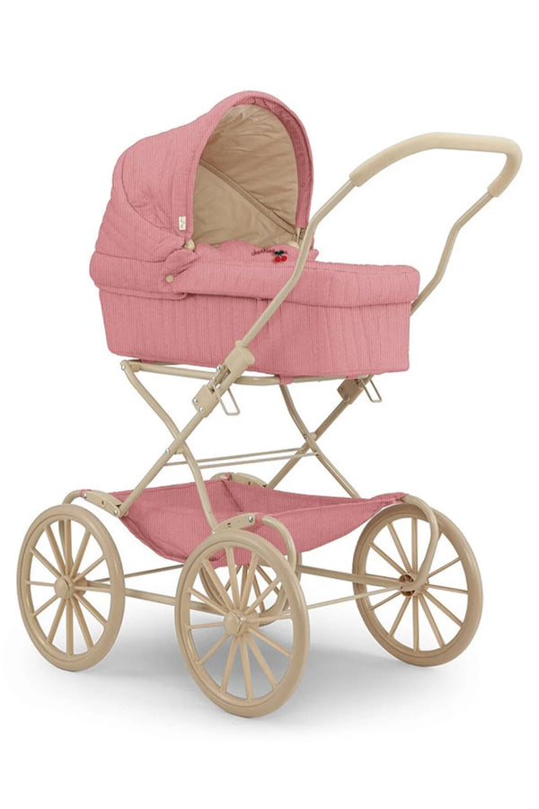 The Konges Sloejd Lulu Doll Pram - Cherry showcases a classic design with a pink quilted cover, a padded mattress, and a beige frame. It features large spoked wheels and a curved handle for that vintage-style charm.