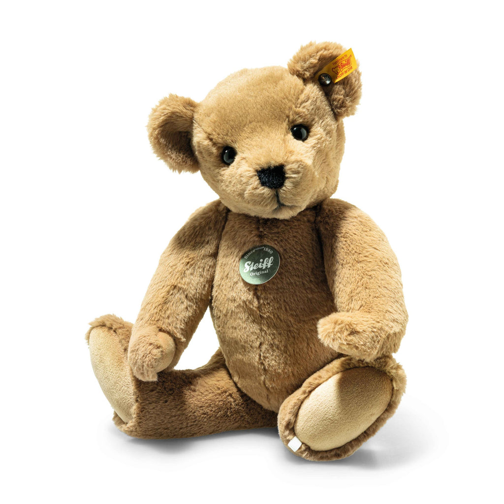 The Steiff Lio Teddy Bear is a classic brown plush bear with a yellow ear tag and green Steiff Button in Ear, sitting upright with bent limbs, crafted from recycled PET plush for an eco-friendly hug.