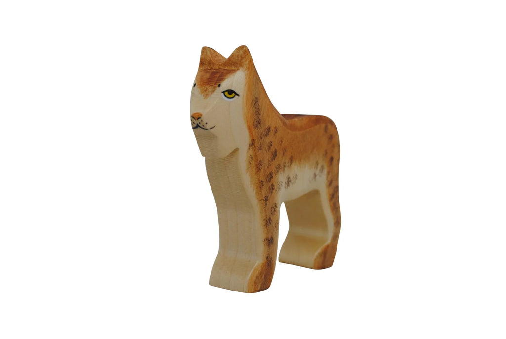 A small wooden toy figure painted to resemble a standing lynx. Crafted by Holzwald Brand, the lynx has distinct spots, a light brown body, and a detailed face with prominent eyes. This sustainable toy is both charming and eco-friendly.