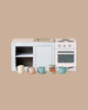 The Maileg Fully Furnished SuitCasa is a small toy kitchen set with a stove, oven, sink, shelves, four mini cups, pitcher, tomato can, and kitchen accessories—perfect for any mouse house and displayed on a plain beige background.