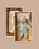PRE-ORDER: Little Brother Mouse in Matchbox features a small mouse in blue polka-dot pajamas resting on soft bedding inside a vintage-inspired matchbox-style bed. Estimated ship date: early November.