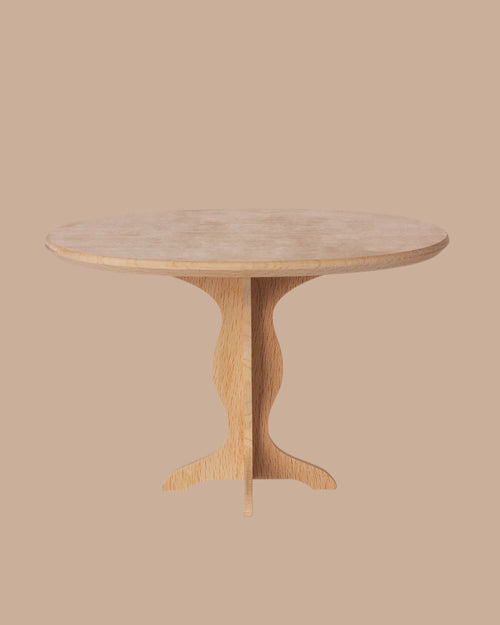 The PRE-ORDER: Oval Table, Mini - Nature (ships early October) features a light wood finish, fine craftsmanship, and a sculpted central pedestal base, presented against a plain beige background.