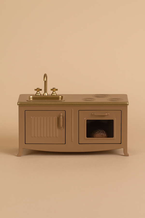 The Maileg Kitchen - Light Brown is a miniature toy kitchen set with a sink, faucet, stovetop, cabinet, and oven with a tiny loaf of bread—ideal for any mouse family—displayed against a beige background.