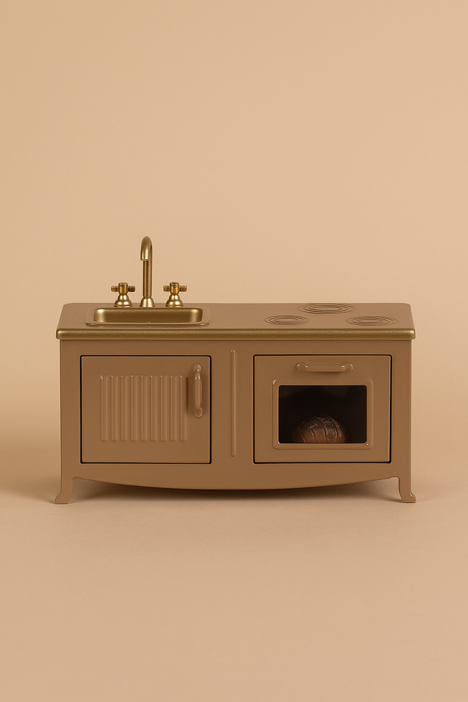 The Maileg Kitchen - Light Brown is a miniature toy kitchen set with a sink, faucet, stovetop, cabinet, and oven with a tiny loaf of bread—ideal for any mouse family—displayed against a beige background.