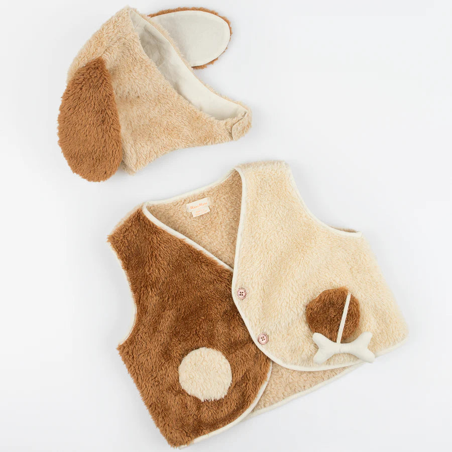 The Meri Meri Puppy Costume - Final Sale is a baby's fuzzy costume set, ideal as a gift for dog lovers. It includes a brown and beige vest featuring a bone decoration and an adorable paw print, along with a matching hat adorned with floppy dog ears. The outfit mimics the look of a puppy's fur and is crafted from cozy Sherpa fleece.