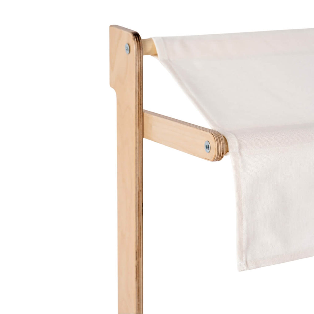 Close-up of the Milton & Goose Market Stand corner, highlighting its light wooden frame and white fabric canopy, with visible screws securing the handcrafted pieces together.