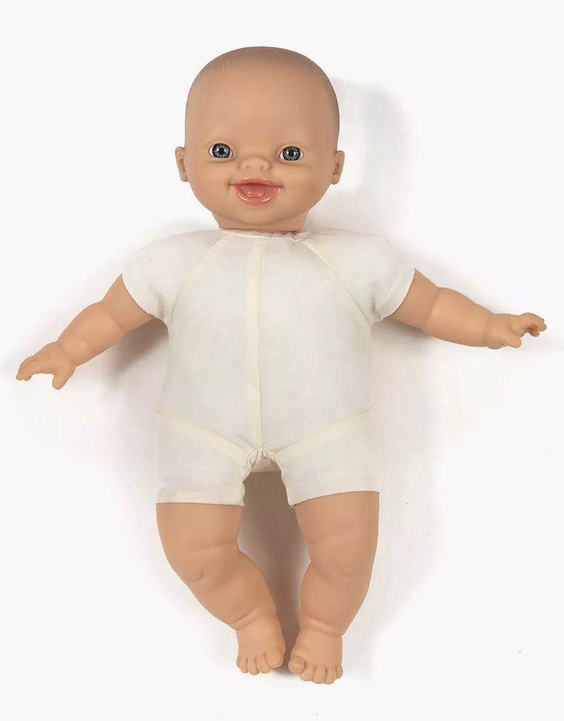 The Minikane Soft Body Doll (11") - Liv, featuring light skin, blue eyes, and a wide smile in a white outfit, is displayed on a plain white background.