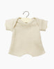 A Minikane Clothing | Honeycomb Knit Shorty Bodysuit hangs on a wooden hanger. The fabric features a textured, honeycomb mesh pattern. Perfect as an 11" doll accessory or for Minikane Babies bodysuit collection, the background is plain white.