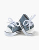 Minikane Doll Shoes | Converse Style Denim Sneakers—small denim sneakers with white rubber toes, laces, and black stripes on the soles, ideal for 34cm or 37cm dolls—are shown on a white background.