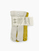 Three pairs of ankle socks are shown bundled together with a label: one pair is white, another light grey, and the third mustard yellow. The label reads "mixa x colutier" with additional care instructions, and proudly states they are made in France. Perfect companion to your Minikane Doll Clothing | Pack of Two Leggings in Ecru and Gold.