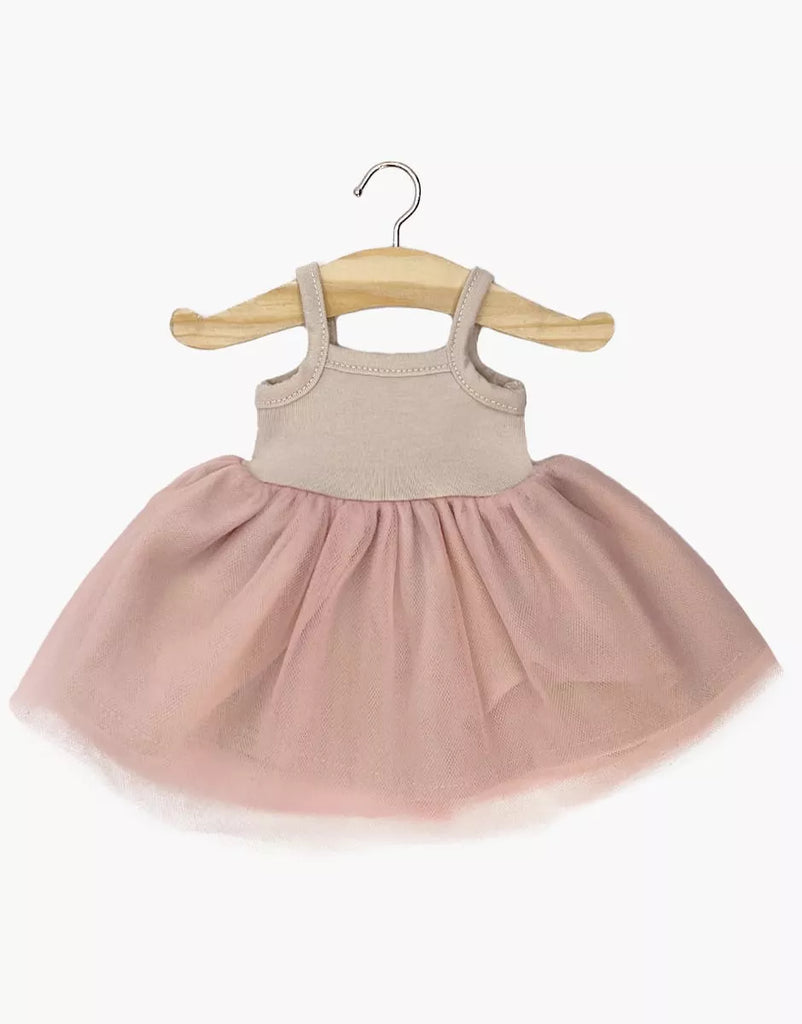 The Minikane Doll Clothing | Rosella Tutu - Pink features a sleeveless beige knit bodice and a light pink tulle skirt, designed in France and shown on a wooden hanger against a white background.