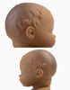 Two close-up side views of the Minikane Doll (13") - Leonie head, showing textured hair and facial features against a white background. The top photo is more zoomed in. Made from phthalate-free vinyl. Clothing sold separately.