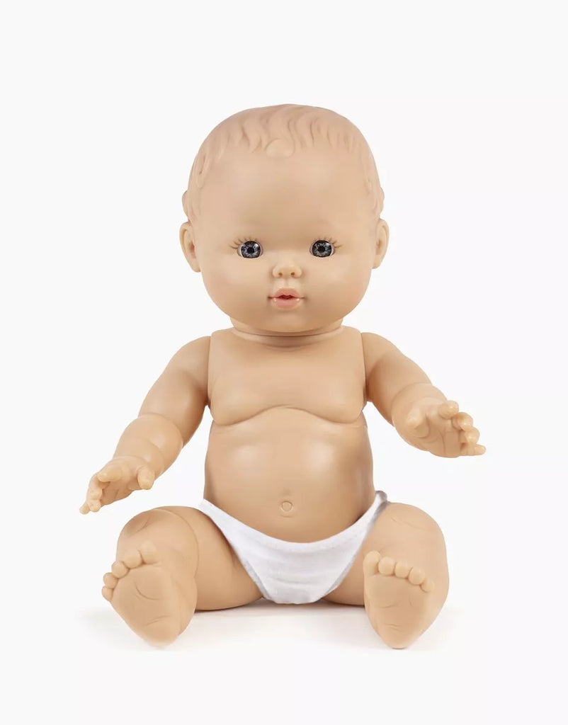 The Minikane Doll (13") - Rosalie, made in Spain from phthalate-free vinyl, features light skin, blue eyes, painted hair, and sits upright in a white diaper. Clothing is sold separately. Background is plain white.