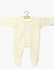 The Minikane 11" Doll Clothing | Sleep Well Corentin Onesie in Ribbed Knit - Yellow features long sleeves, footed legs, and a rounded collar, shown on a wooden hanger against a plain white background.