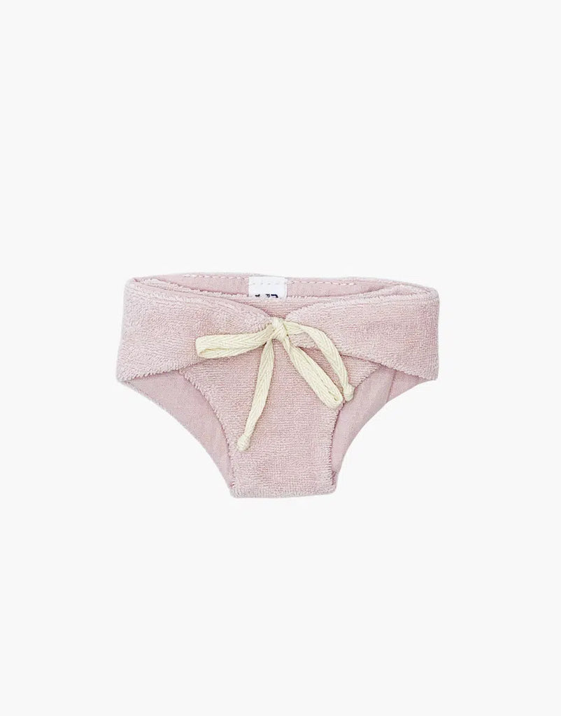 The Minikane Doll Clothing | Petal Pink Diaper is crafted from soft double gauze cotton and features a cream-colored drawstring bow at the front, echoing the delicate style of Minikane Babies, set against a plain white background.