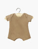 The Minikane 11" Doll Clothing in Cocoa Ribbed Body Shorty features a beige cotton knit romper with short sleeves and a classic round neckline, showcased on a wooden hanger against a plain white background, highlighting its simple elegance and soft texture for infants.