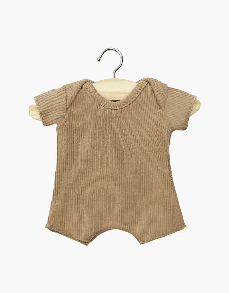 The Minikane 11" Doll Clothing in Cocoa Ribbed Body Shorty features a beige cotton knit romper with short sleeves and a classic round neckline, showcased on a wooden hanger against a plain white background, highlighting its simple elegance and soft texture for infants.