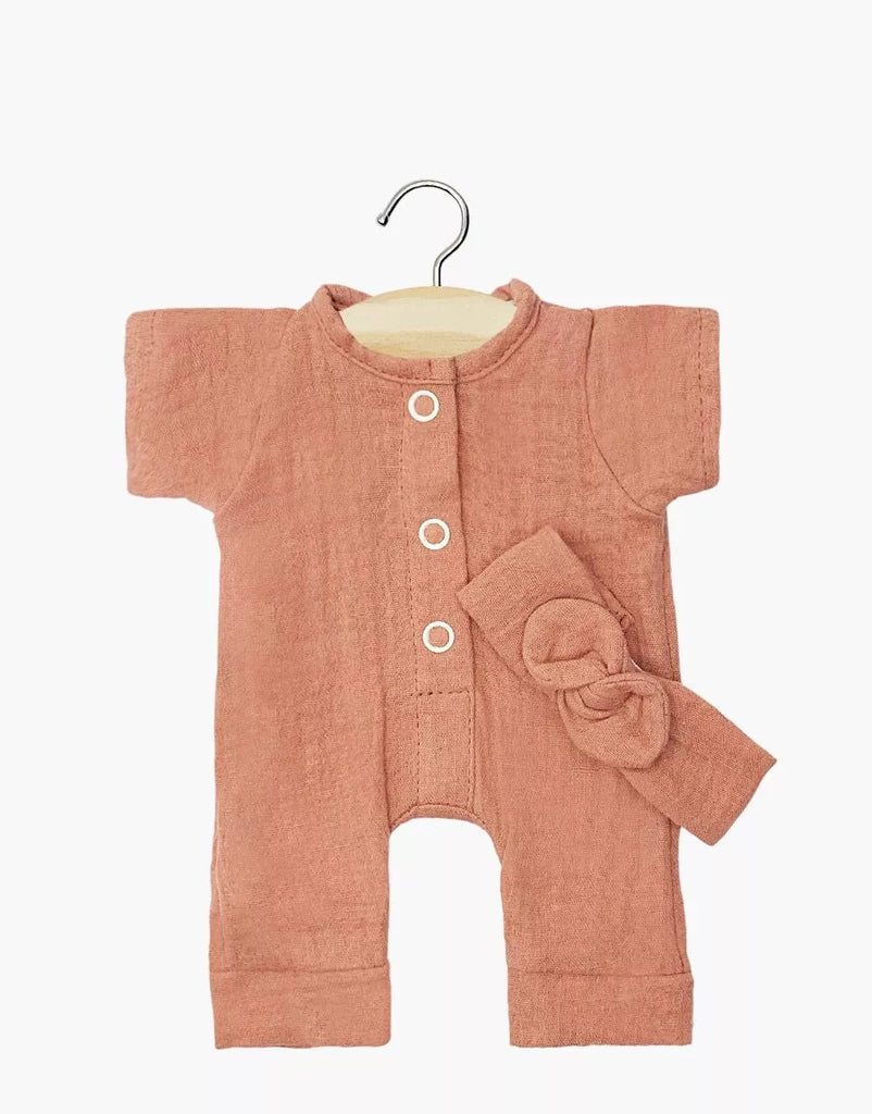 The Minikane 11" Doll Clothing Lili Jumpsuit & Headband in Cotton Gauze - Marsala features a short-sleeve romper with white front buttons and a matching bow headband, both displayed on a hanger.