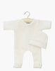 This charming white Minikane Doll Clothing set, named "Sleep well Angel and her linen ribbed hat," includes a ribbed long-sleeve onesie and matching beanie on a wooden hanger against a plain backdrop. Designed in France, it is conveniently hand washable.