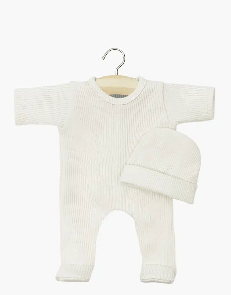 This charming white Minikane Doll Clothing set, named "Sleep well Angel and her linen ribbed hat," includes a ribbed long-sleeve onesie and matching beanie on a wooden hanger against a plain backdrop. Designed in France, it is conveniently hand washable.