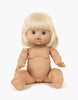 The Minikane Baby Doll (13"), named Angela, features light blonde hair, light skin, and blue eyes. Angela sits upright with her legs spread and arms extended forward. This anatomically correct doll is unclothed and has a neutral facial expression. (Clothing sold separately.)