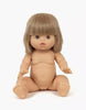 A Minikane Baby Doll With Sleeping Eyes (13") - Yzé, featuring short, straight brown hair and blue eyes, is positioned upright. The anatomically correct doll is unclothed with its arms extended slightly forward and legs apart on a plain white background. Clothing for the doll is sold separately.