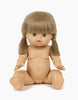 A Minikane Baby Doll (13") - Yzé with a beige skin tone, sitting upright. The anatomically correct doll has short, light brown hair styled in two low pigtails, blue eyes, and no clothes. The background is plain white.