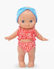 The Mini Pancha Doll - Alice with Coral Gingham Outfit features big eyes and stands facing forward, wearing a coral and white checkered ruffled bikini with a blue headband, against a plain white background—perfect for imaginative play and crafted from high-quality vinyl.