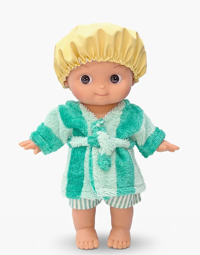 The Mini Pancha Doll - Basile with Green Striped Bath Set features a Paola Reina doll with big eyes, dressed in a yellow shower cap, a green and white striped bathrobe, and matching shorts. Barefoot and posed against a plain white background, this doll is perfect for imaginative play.
