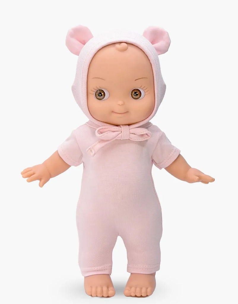 The Mini Pancha Doll - Ninon comes dressed in a pale pink mouse outfit with a hood featuring adorable mouse ears. This handcrafted vinyl doll stands upright with arms slightly outstretched, making it perfect for inspiring imaginative play.