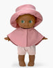 A high-quality vinyl Minikane Mini Pancha Doll - Prunelle with Pink Rain Suit, featuring dark skin, green eyes, a pink sun hat, a short pink cape, and pink shorts.