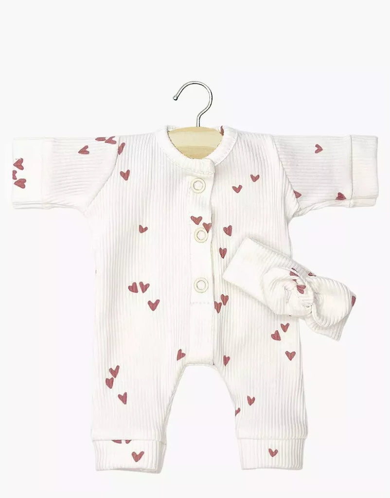 The Minikane 11" Doll Clothing Lili Jumpsuit & Headband in Ribbed Knit - Pink Hearts features a white onesie with pink hearts and a matching knotted headband, perfect for dressing up your Minikane doll.