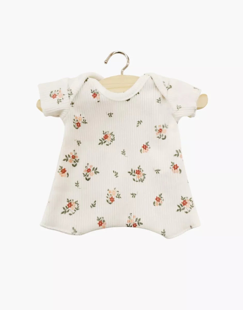 A Minikane 11" Doll Shorty Bodysuit in ribbed knit with small pink and green flowers, short sleeves, and white base, displayed on a wooden hanger against a white background.