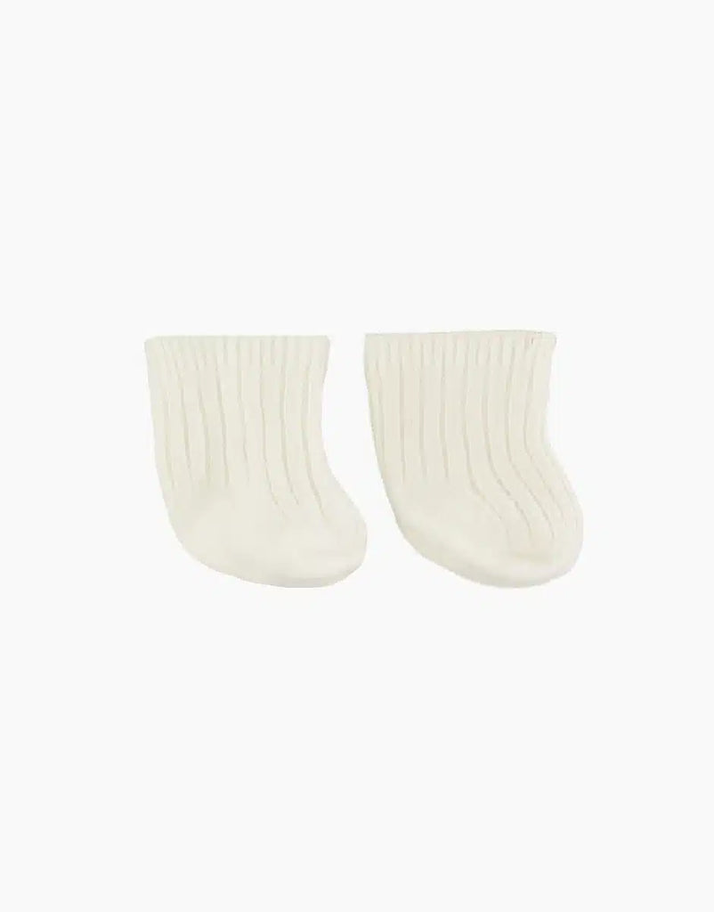 A pair of white, ribbed Collégien cotton socks are displayed against a plain white background. The socks, perfect as doll accessories, are positioned next to each other with the toes facing to the right. The ribbed texture is visible, giving these Minikane Doll Clothing | Beige Cotton Doll Socks a stretchy appearance.