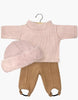 Set against a white background, the Minikane Doll Clothing includes a petal ribbed knit undershirt and brown sugar spandex pants with foot straps, plus a matching furry hat. Ideal for those seeking doll accessories that echo the charm of Minikane dolls and French elegance.